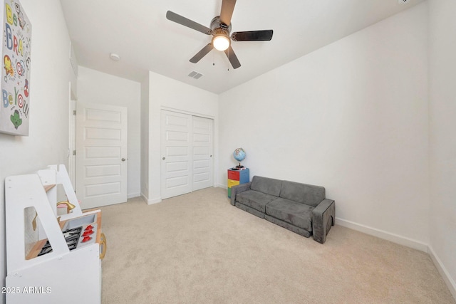 sitting room with baseboards, ceiling fan, carpet flooring, and visible vents