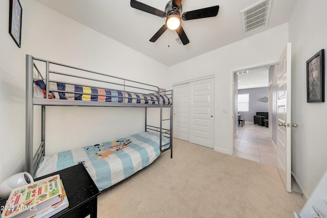 carpeted bedroom featuring visible vents, a ceiling fan, baseboards, and a closet