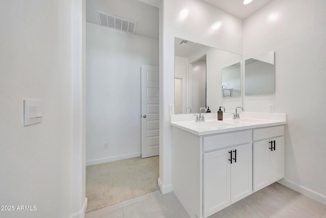 bathroom featuring double vanity, visible vents, and a sink
