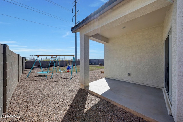 view of patio / terrace with a fenced backyard and a playground