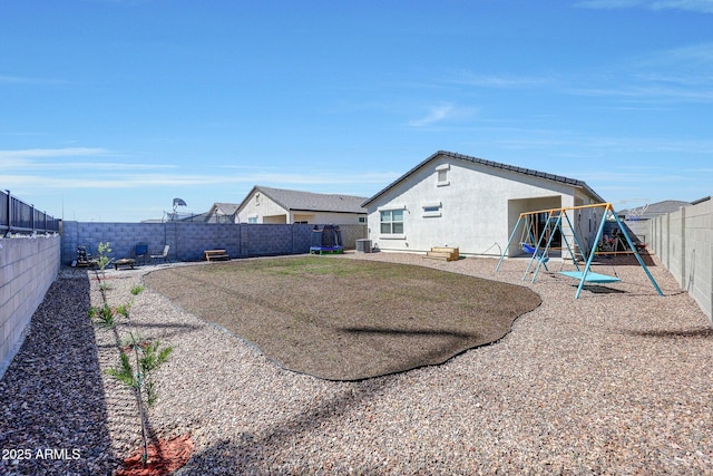 view of yard with a playground, cooling unit, and a fenced backyard