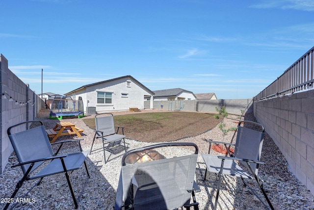view of patio featuring a fenced backyard and a trampoline