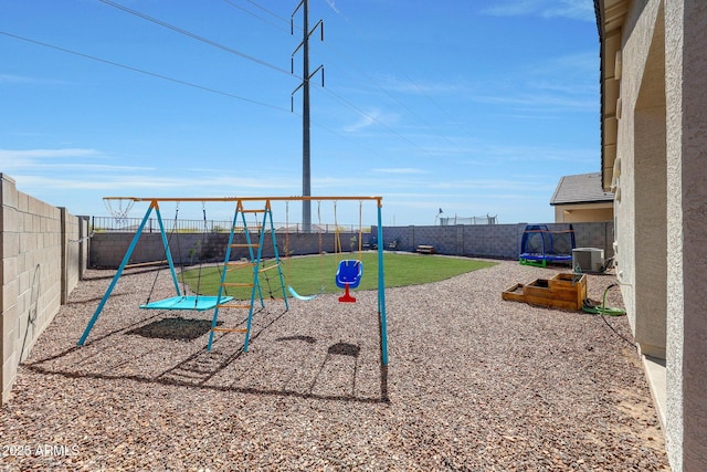 view of jungle gym featuring central AC and a fenced backyard