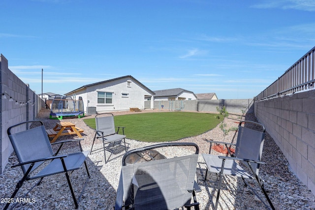 view of patio / terrace with a fenced backyard and a trampoline