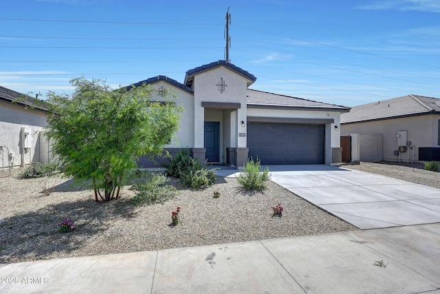 single story home featuring a tiled roof, an attached garage, concrete driveway, and stucco siding