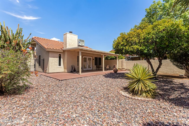 1382 N Tamarisk Dr, Chandler, AZ 85224 - rear view of property featuring a chimney, a patio, stucco siding, a tiled roof, and french doors