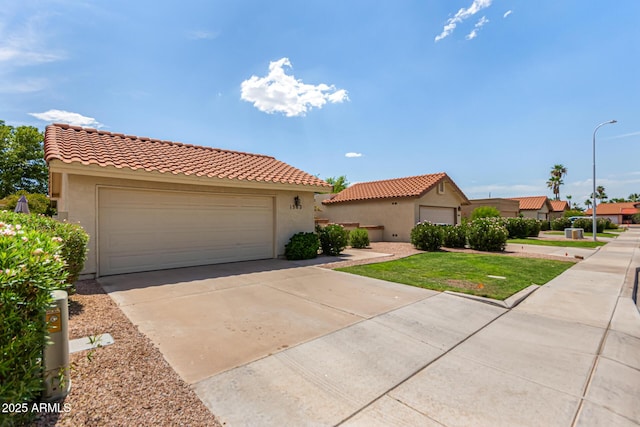 1382 N Tamarisk Dr, Chandler, AZ 85224 - mediterranean / spanish house featuring a garage, stucco siding, and a tile roof