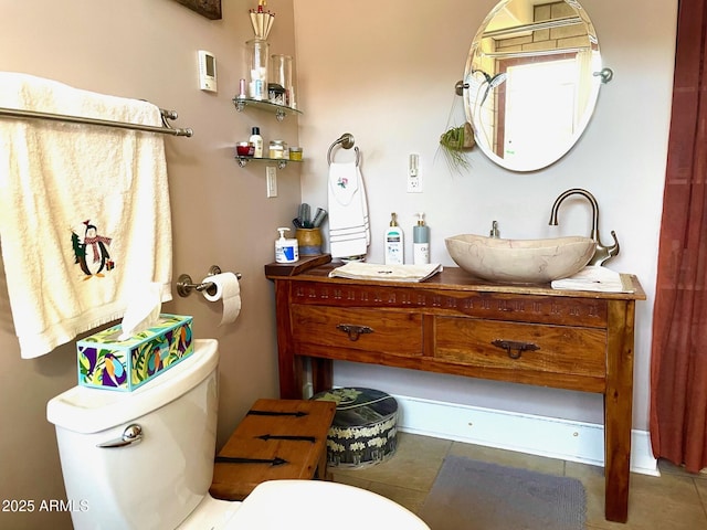 bathroom with tile patterned flooring, vanity, and toilet