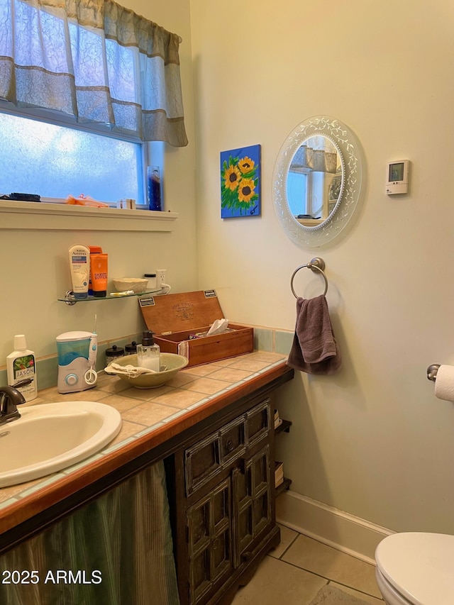 bathroom with tile patterned floors, vanity, and toilet