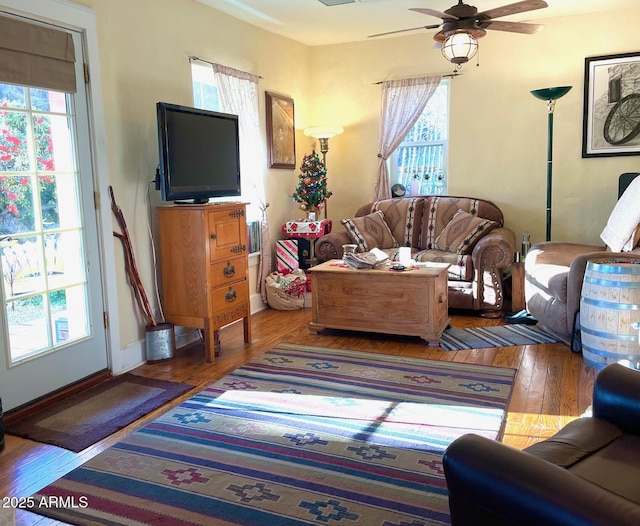 living room featuring hardwood / wood-style flooring and ceiling fan