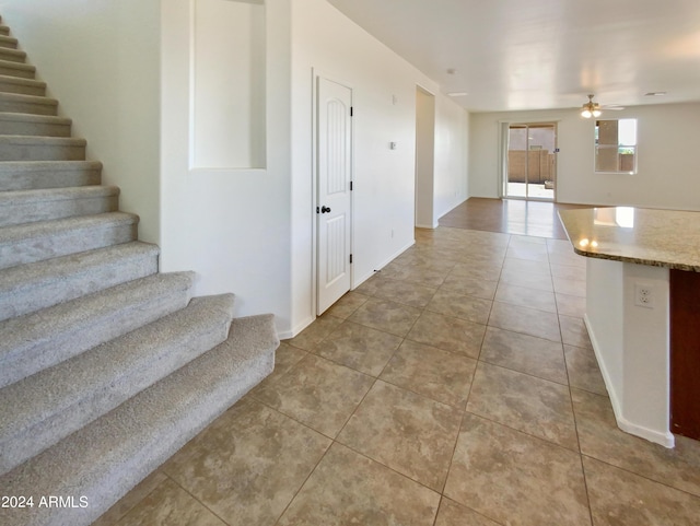 interior space featuring ceiling fan and tile patterned floors