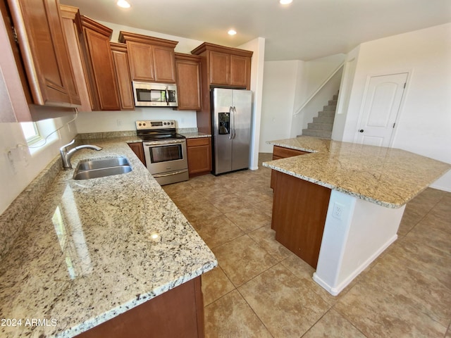 kitchen featuring light stone countertops, appliances with stainless steel finishes, sink, and light tile patterned flooring