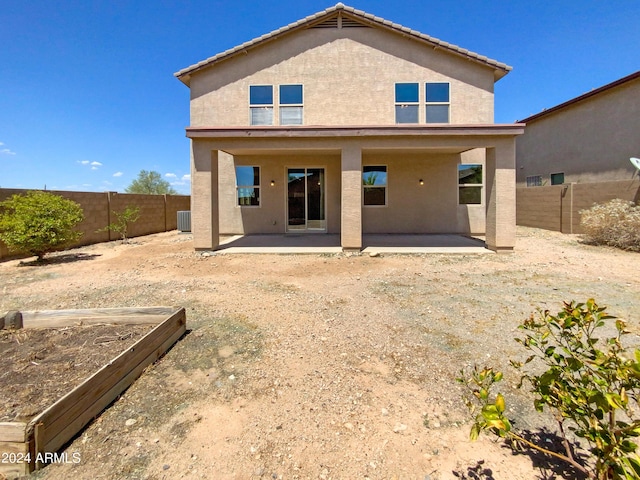 rear view of property with central AC and a patio area