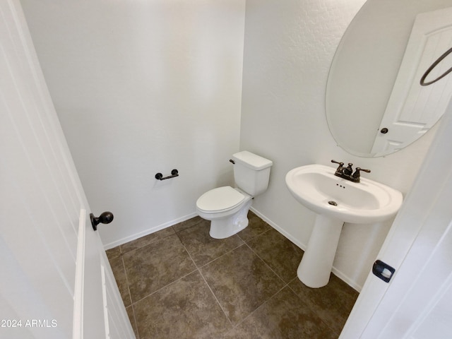 bathroom featuring sink, tile patterned floors, and toilet