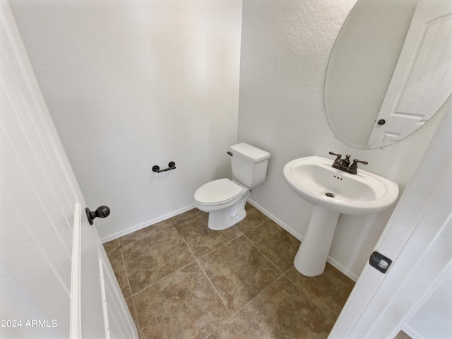 bathroom featuring tile patterned floors and toilet