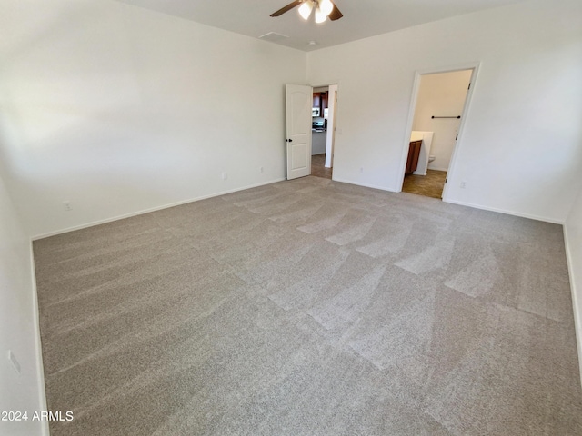 unfurnished bedroom featuring connected bathroom, carpet floors, and ceiling fan