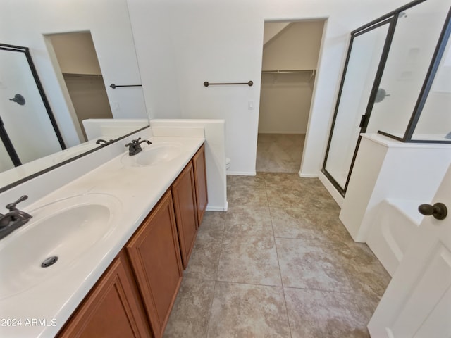 bathroom featuring tile patterned floors, vanity, and plus walk in shower