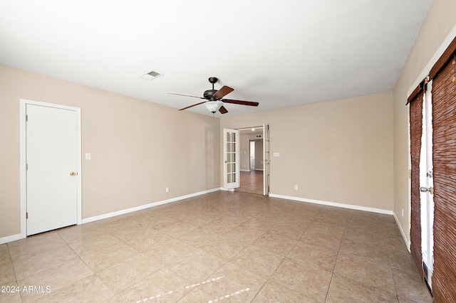 tiled empty room with french doors and ceiling fan