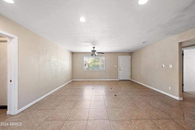 empty room with light tile patterned floors and ceiling fan