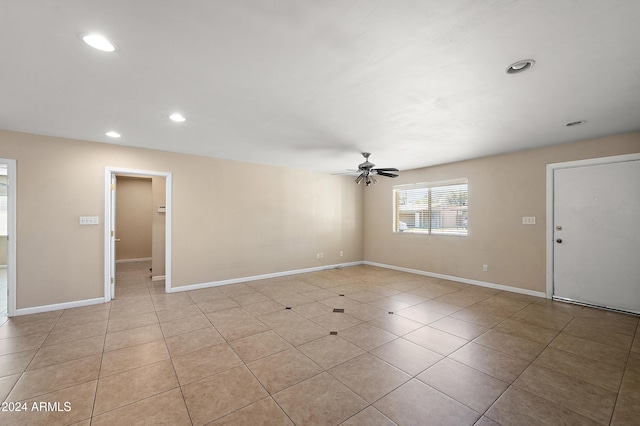 empty room featuring light tile patterned floors and ceiling fan