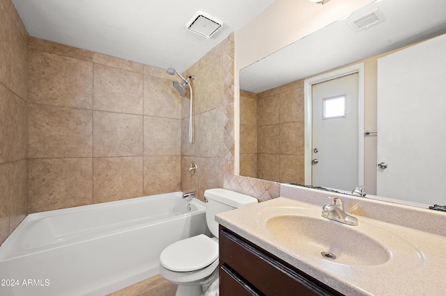 full bathroom featuring toilet, tiled shower / bath combo, and vanity