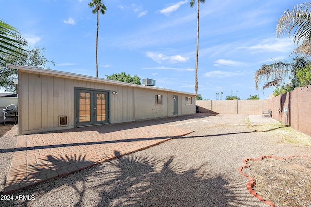 rear view of house with french doors, a patio area, and central air condition unit