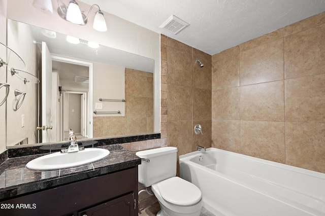 full bathroom with vanity, toilet, tiled shower / bath combo, and tile walls