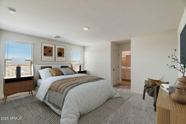 bedroom with baseboards, visible vents, and light colored carpet