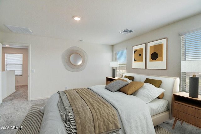 bedroom with light carpet, multiple windows, and visible vents