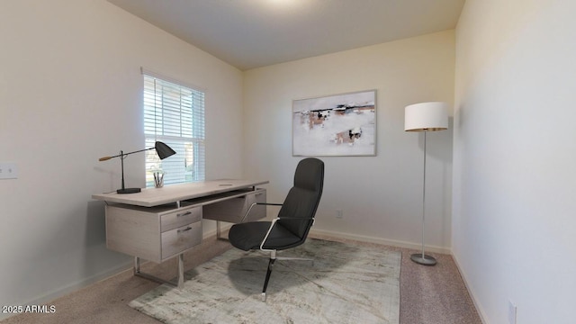 office area with light carpet and baseboards