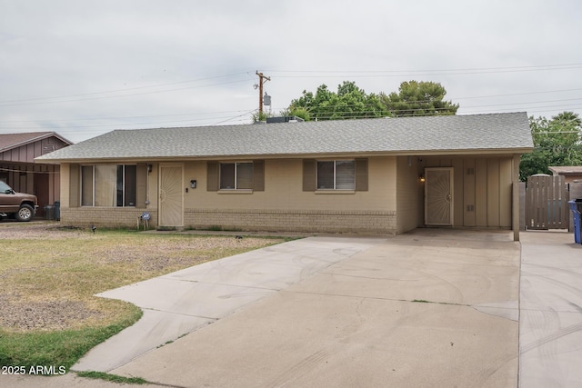 5813 N 39th Ave, Phoenix, AZ 85019 - ranch-style home with brick siding, driveway, a carport, and a shingled roof
