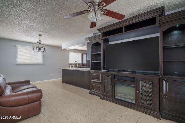 5813 N 39th Ave, Phoenix, AZ 85019 - living area with a chandelier, ceiling fan, light tile patterned flooring, baseboards, and a textured ceiling