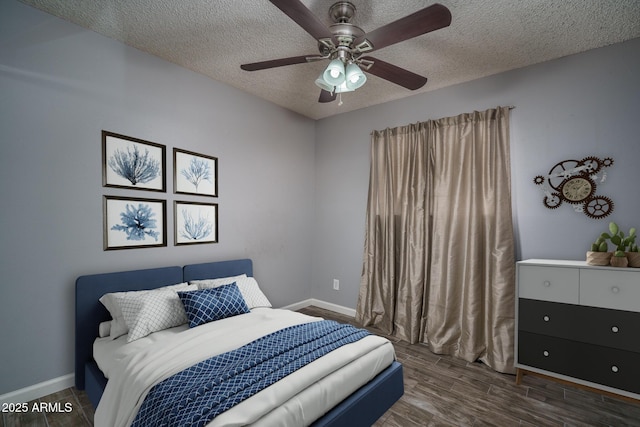 5813 N 39th Ave, Phoenix, AZ 85019 - bedroom with a textured ceiling, wood finished floors, baseboards, and a ceiling fan