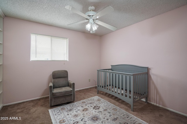 5813 N 39th Ave, Phoenix, AZ 85019 - carpeted bedroom with a textured ceiling, a nursery area, ceiling fan, and baseboards