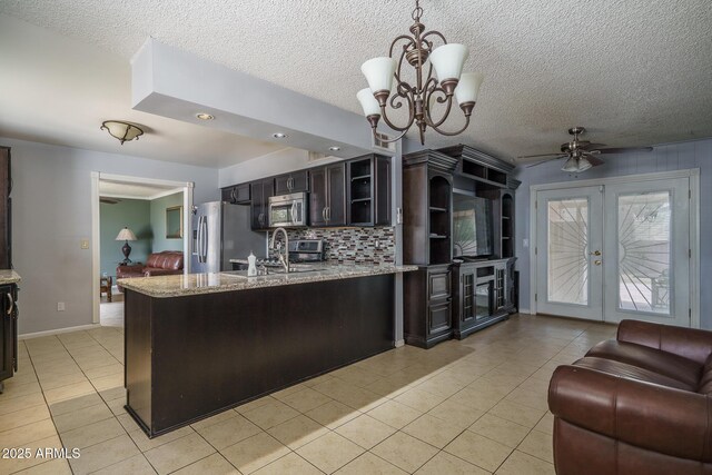 5813 N 39th Ave, Phoenix, AZ 85019 - kitchen featuring appliances with stainless steel finishes, light tile patterned flooring, a ceiling fan, a peninsula, and a textured ceiling