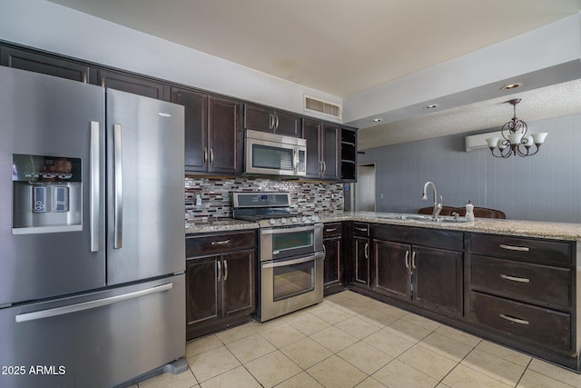 5813 N 39th Ave, Phoenix, AZ 85019 - kitchen with appliances with stainless steel finishes, light tile patterned flooring, a sink, a chandelier, and dark brown cabinetry