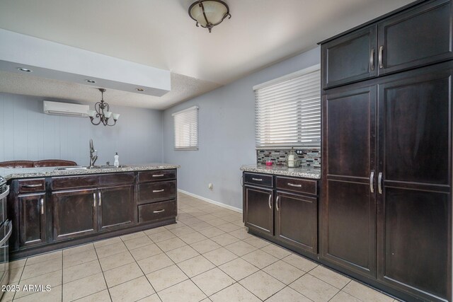 5813 N 39th Ave, Phoenix, AZ 85019 - kitchen featuring a sink, a wall mounted air conditioner, light tile patterned floors, a chandelier, and baseboards