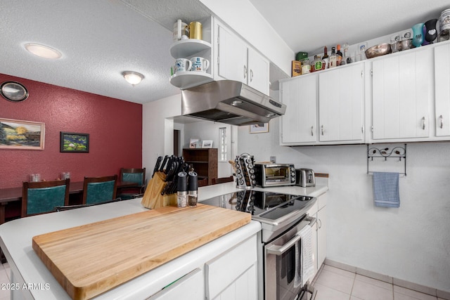 kitchen featuring light tile patterned floors, a textured ceiling, white cabinetry, and electric stove