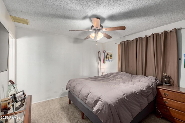 carpeted bedroom with a textured ceiling and ceiling fan