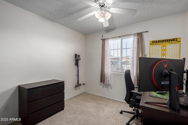 carpeted home office with a textured ceiling and ceiling fan