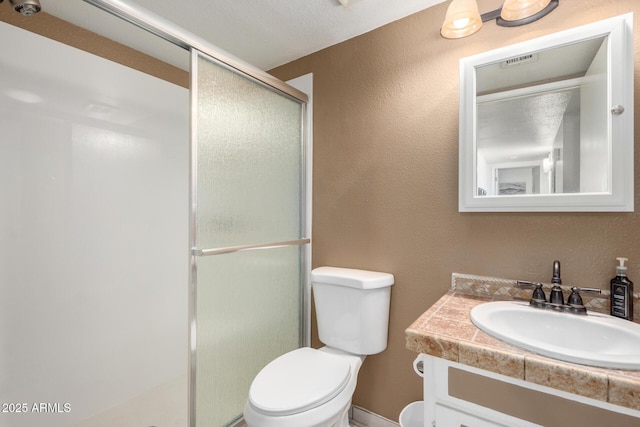 bathroom with walk in shower, vanity, and toilet