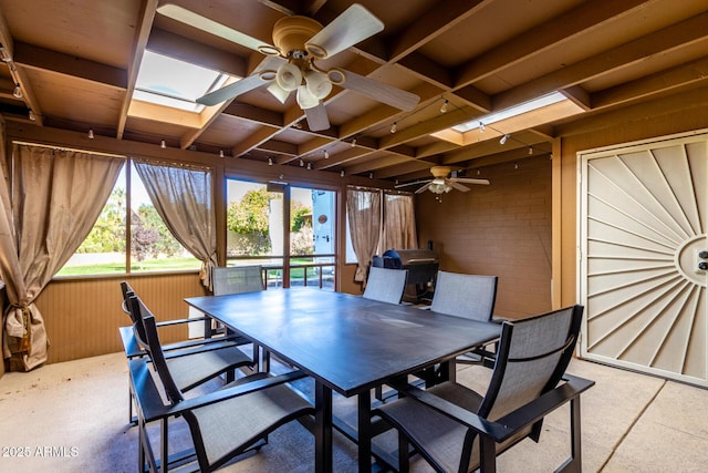 sunroom / solarium featuring a skylight, ceiling fan, and rail lighting