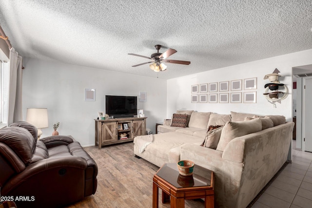 living room featuring a textured ceiling and ceiling fan