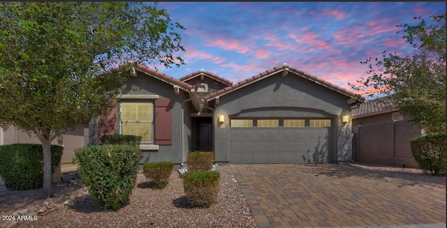 4218 W Palace Station Rd, New River, AZ 85087 - view of front facade with a garage, a tile roof, decorative driveway, and stucco siding