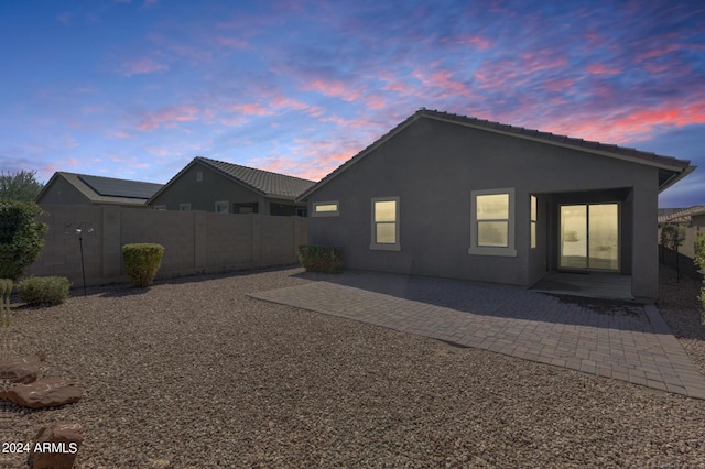 4218 W Palace Station Rd, New River, AZ 85087 - back of property featuring a patio, stucco siding, and a tiled roof