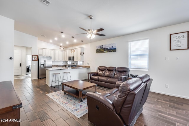 4218 W Palace Station Rd, New River, AZ 85087 - living room with ceiling fan, dark wood-type flooring, vaulted ceiling, and baseboards
