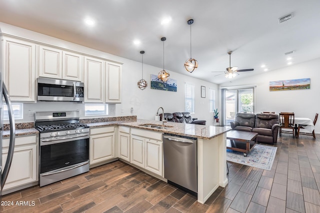 4218 W Palace Station Rd, New River, AZ 85087 - kitchen with appliances with stainless steel finishes, a sink, dark wood-style floors, a peninsula, and recessed lighting