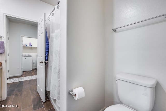 4218 W Palace Station Rd, New River, AZ 85087 - full bath featuring toilet, wood finished floors, washer / clothes dryer, and curtained shower