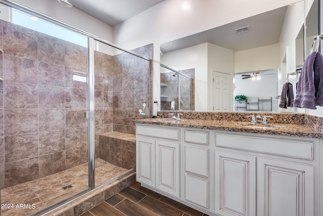 4218 W Palace Station Rd, New River, AZ 85087 - full bathroom featuring a stall shower, double vanity, ceiling fan, and wood finished floors