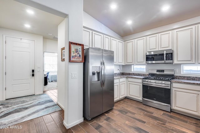 4218 W Palace Station Rd, New River, AZ 85087 - kitchen featuring stainless steel appliances, wood finish floors, stone counters, vaulted ceiling, and recessed lighting